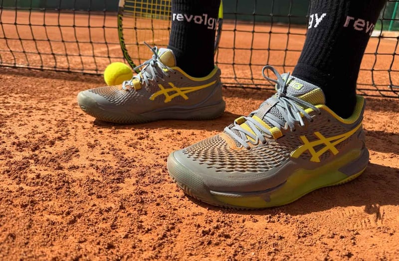 Photo of tennis shoes and Revolgy socks on a tennis court