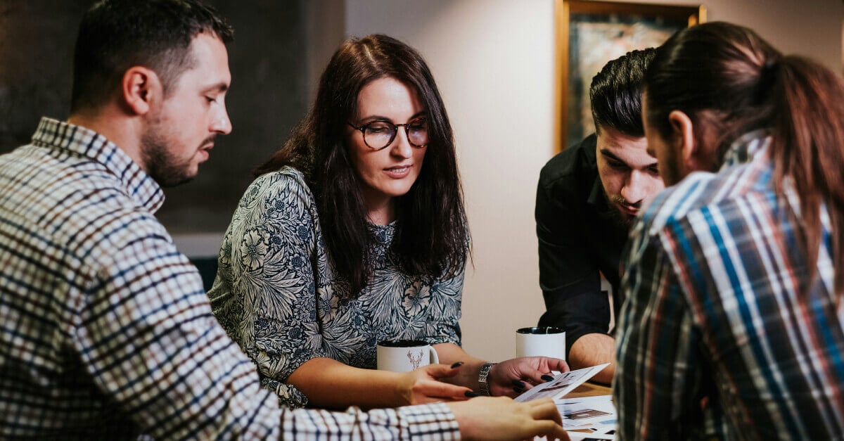 A group of people discussing work